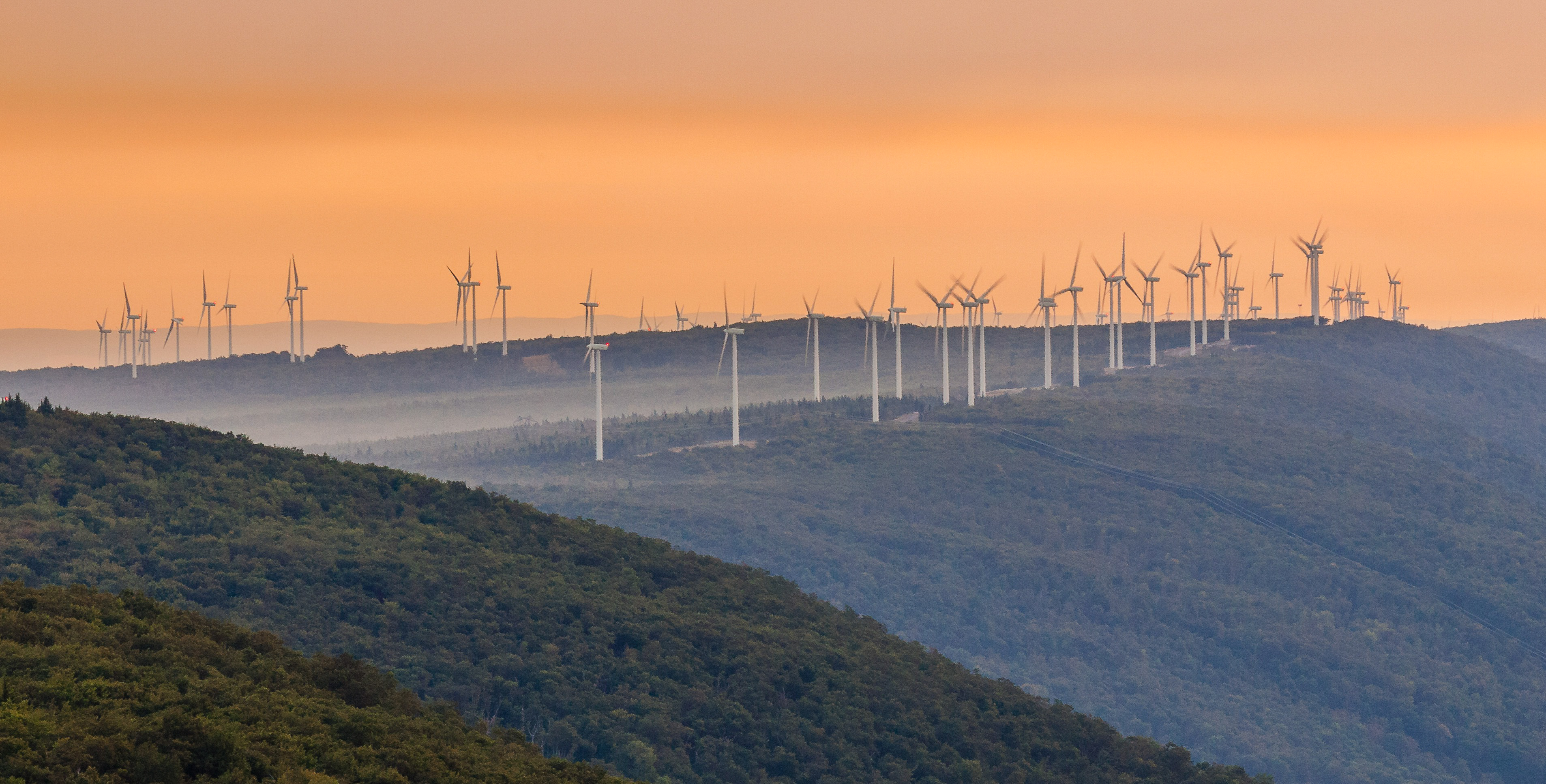 Wind turbines on a hillside.